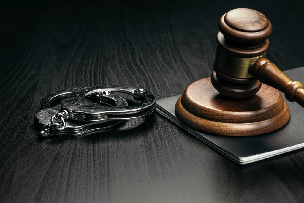 A judge's gavel and handcuffs rest on a dark surface, symbolizing law and justice in Florida.